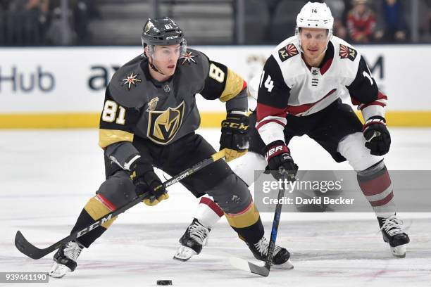 Jonathan Marchessault of the Vegas Golden Knights skates with the puck while Richard Panik of the Arizona Coyotes defends during the game at T-Mobile...