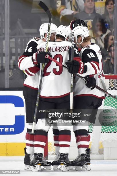 Kevin Connauton celebrates his goal with his teammates Oliver Ekman-Larsson and Christian Dvorak of the Arizona Coyotes against the Vegas Golden...