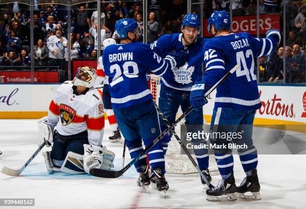 James van Riemsdyk of the Toronto Maple Leafs celebrates his goal on Roberto Luongo of the Florida Panthers with teammates Connor Brown and Tyler...