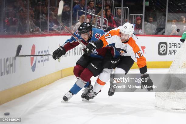 Matt Nieto of the Colorado Avalanche battles for position against Andrew MacDonald of the Philadelphia Flyers at the Pepsi Center on March 28, 2018...