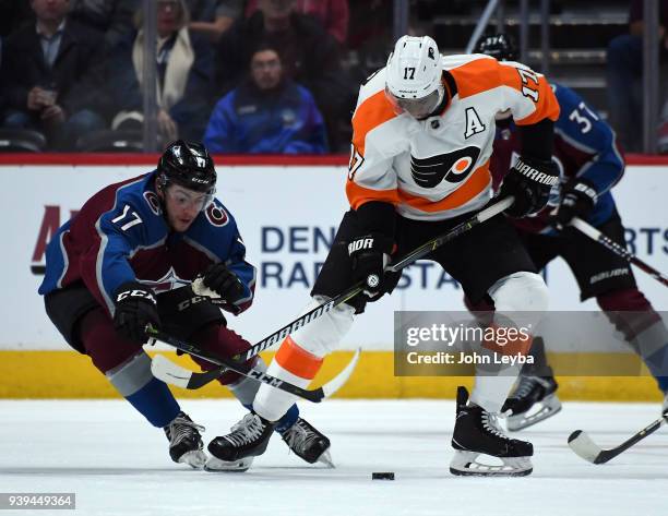 Philadelphia Flyers right wing Wayne Simmonds and Colorado Avalanche center Tyson Jost go after the puck during the first period on March 28, 2018 at...