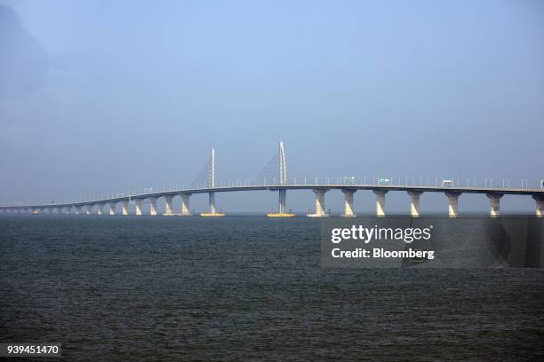 Boat sails towards a section of the Hong Kong-Zhuhai-Macau Bridge standing offshore in Zhuhai, China, on Wednesday, March 28, 2018. The multibillion...