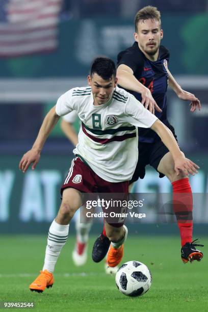 Hirving Lozano of Mexico fights for the ball with Filip Bradaric of Croatia during the international friendly match between Mexico and Croatia at...