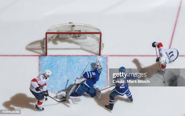 Frederik Andersen of the Toronto Maple Leafs makes a save on Jonathan Huberdeau of the Florida Panthers as Ron Hainsey of the Toronto Maple Leafs...