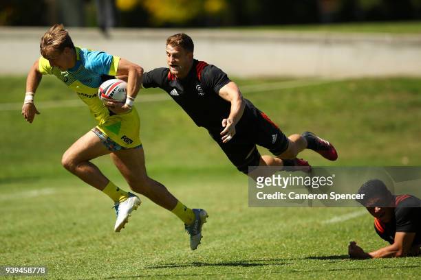 John Porch of Australia is tackled during the Australian Rugby Sevens practice match against New Zealand at Newington College on March 29, 2018 in...