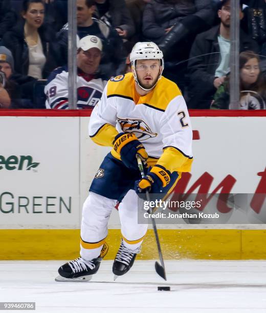 Anthony Bitetto of the Nashville Predators plays the puck up the ice during first period action against the Winnipeg Jets at the Bell MTS Place on...