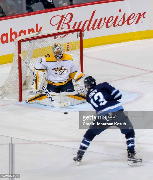 Brandon Tanev of the Winnipeg Jets takes a shot on goaltender Juuse Saros of the Nashville Predators during third period action at the Bell MTS Place...
