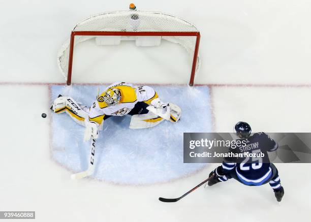 Paul Stastny of the Winnipeg Jets watches as goaltender Juuse Saros of the Nashville Predators makes a kick save during the overtime period at the...