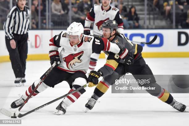 Max Domi of the Arizona Coyotes skates with the puck while Colin Miller of the Vegas Golden Knights defends during the game at T-Mobile Arena on...