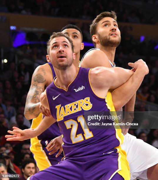 Travis Wear of the Los Angeles Lakers and Maximilian Kleber of the Dallas Mavericks battle under the basket in the first half of the game at Staples...