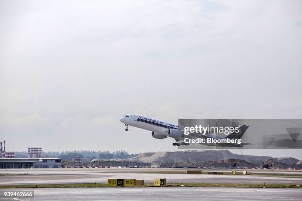 An Airbus SE A350-941 aircraft, operated by Singapore Airlines Ltd. , takes off from Changi Airport in Singapore, on Wednesday, March 28, 2018....