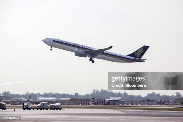 An Airbus SE A330-343 aircraft, operated by Singapore Airlines Ltd. , takes off from Changi Airport in Singapore, on Wednesday, March 28, 2018....
