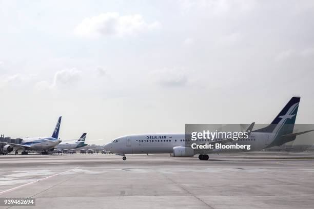 Boeing Co. 737-800 aircraft operated by SilkAir Singapore Pte., a unit of Singapore Airlines Ltd. , taxies along the tarmac at Changi Airport in...