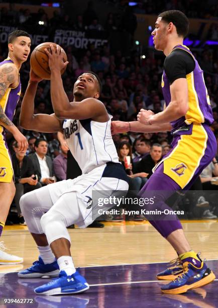 Lonzo Ball of the Los Angeles Lakers guards Dennis Smith Jr. #1 of the Dallas Mavericks as he drives to the basket in the first half of the game at...