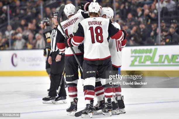 Kevin Connauton celebrates his goal with teammates Christian Dvorak and Max Domi of the Arizona Coyotes against the Vegas Golden Knights during the...