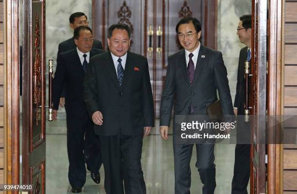 In this handout photo, South Korean Unification Minister Cho Myoung-Gyon walks with North Korean delegation head Ri Son-Gwon before their meeting on...