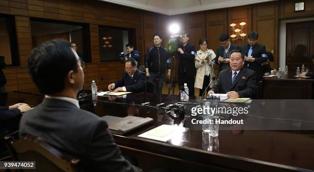 In this handout photo, South Korean Unification Minister Cho Myoung-Gyon talks with North Korean delegation head Ri Son-Gwon during their meeting on...