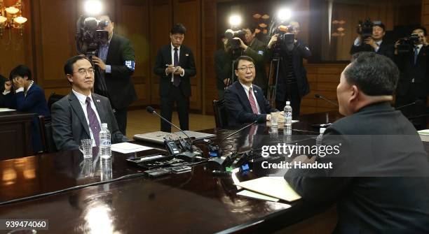 In this handout photo, South Korean Unification Minister Cho Myoung-Gyon talks with North Korean delegation head Ri Son-Gwon before their meeting on...