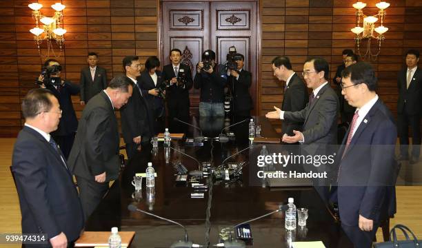 In this handout photo, South Korean Unification Minister Cho Myoung-Gyon talks with North Korean delegation head Ri Son-Gwon during their meeting on...