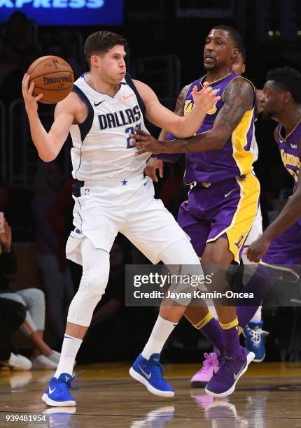 Kentavious Caldwell-Pope of the Los Angeles Lakers guards Doug McDermott of the Dallas Mavericks in the second half of the game at Staples Center on...