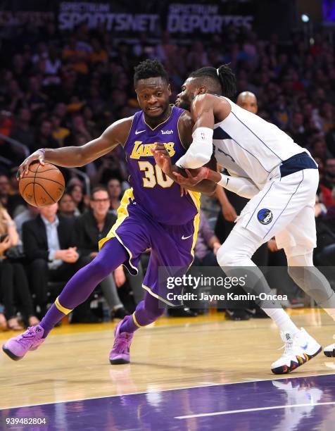 Nerlens Noel of the Dallas Mavericks defends Julius Randle of the Los Angeles Lakers as he drives to the basket in the second half of the game at...