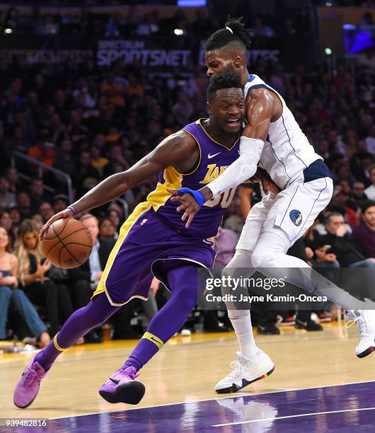 Nerlens Noel of the Dallas Mavericks defends Julius Randle of the Los Angeles Lakers as he drives to the basket in the second half of the game at...