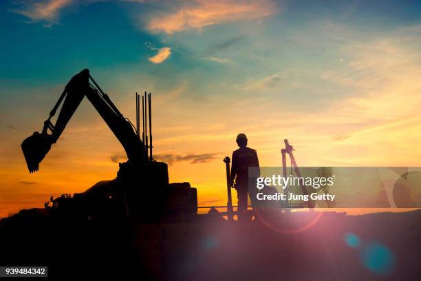 construction equipment's silhouette on sunset - arqueología fotografías e imágenes de stock