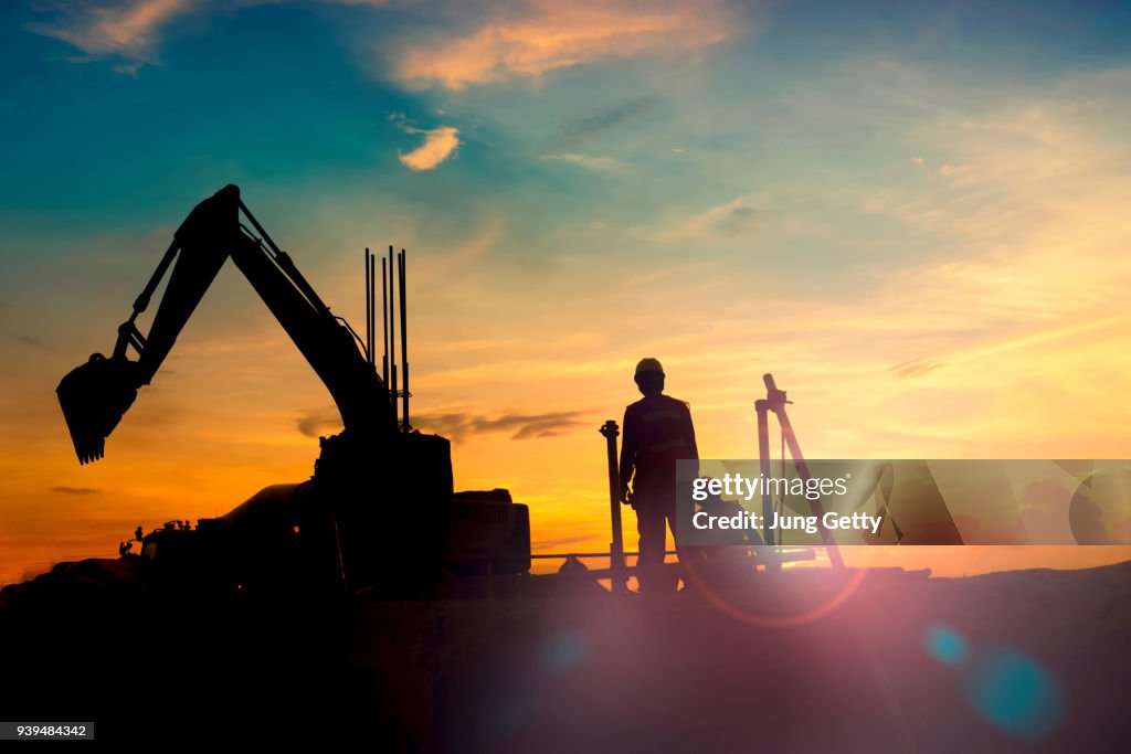 Construction equipment's silhouette on sunset