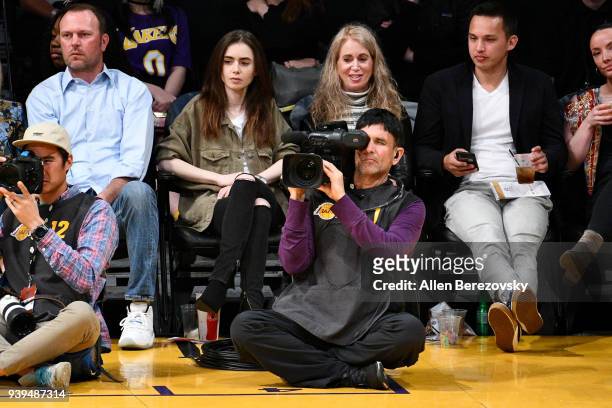 Actress Lily Collins and Jill Tavelman attend a basketball game between the Los Angeles Lakers and the Dallas Mavericks at Staples Center on March...
