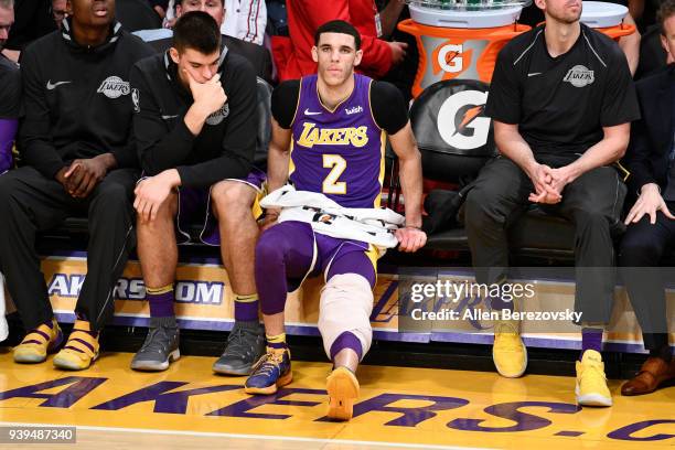 Lonzo Ball of the Los Angeles Lakers ices a sore knee during the second half of a basketball game against the Dallas Mavericks at Staples Center on...