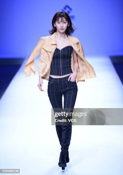 Model showcases designs on the runway at COTTON USA show by designers Chen Wen & Adriano Goldschmied on day four of Mercedes-Benz China Fashion Week...