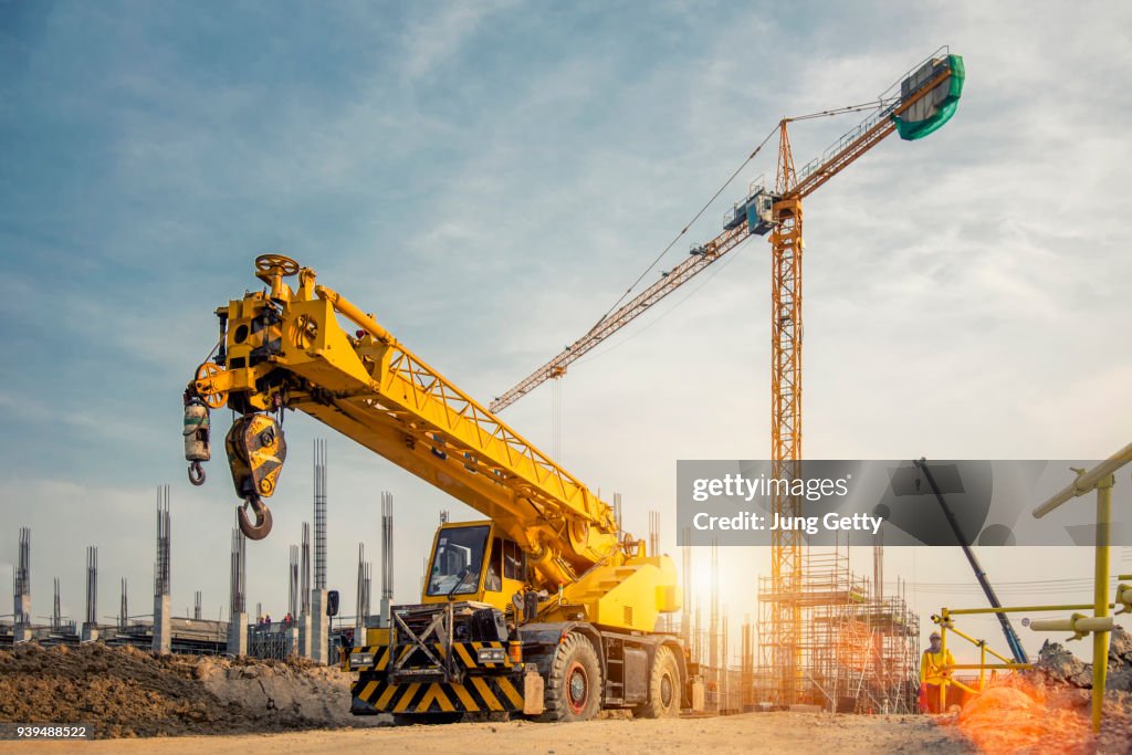 Mobile Crane on a road and tower crane in construction site