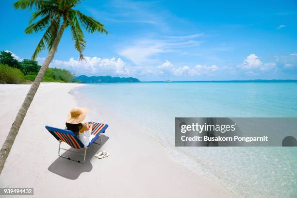 happy woman sunhat on the beach sitting on deckchair, vacation and travel concept - kids swimsuit models stockfoto's en -beelden