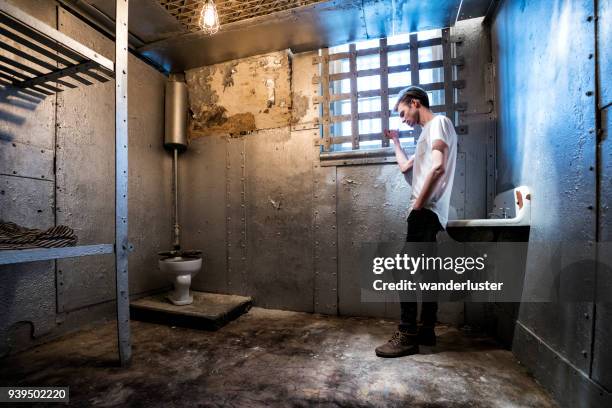 man trapped in prison cell - jail bed stock pictures, royalty-free photos & images