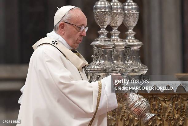 Pope Francis leads the Holy Chrism Mass on Maundy Thursday on March 29, 2018 at St Peter's basilica in Vatican. Christians around the world are...