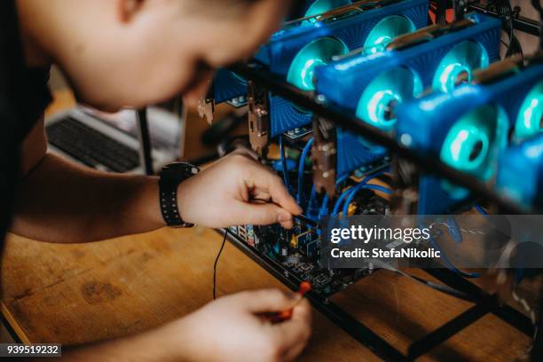 man mining for bitcoin - bitcoin mining stock pictures, royalty-free photos & images