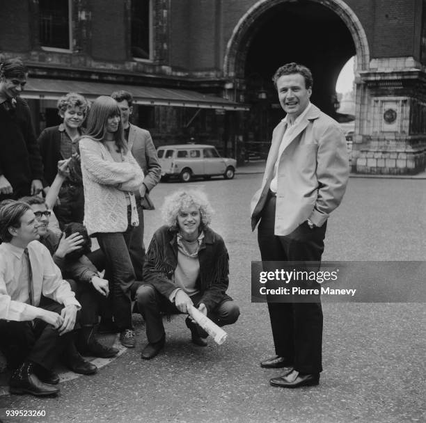 English conductor Colin Davis talking to all night queuers at the Albert Hall for 'The Proms' concerts, London, UK, 18th July 1968.