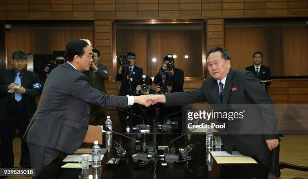 In this handout photo provided by the Ministry of Unification, South Korean Unification Minister Cho Myoung-Gyon shakes hands with North Korean...