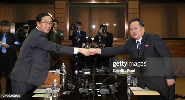 In this handout photo provided by the Ministry of Unification, South Korean Unification Minister Cho Myoung-Gyon shakes hands with North Korean...