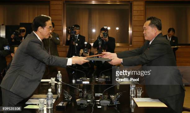 In this handout photo provided by the Ministry of Unification, South Korean Unification Minister Cho Myoung-Gyon and North Korean delegation head Ri...