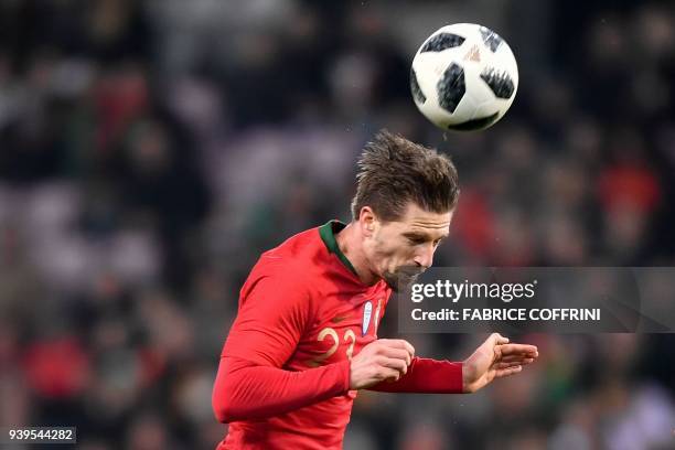 Portugal's midfielder Adrien Silva heads the ball during the international friendly football match between Portugal and Netherlands at Stade de...