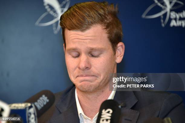 Cricketer Steve Smith reacts at a press conference at the airport in Sydney on March 29 after returning from South Africa. Distraught Australian...