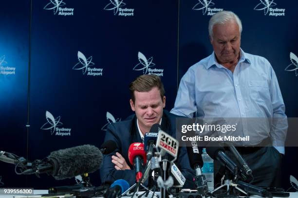 An emotional Steve Smith is comforted by his father Peter as he fronts the media at Sydney International Airport on March 29, 2018 in Sydney,...