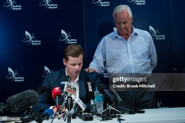 An emotional Steve Smith is comforted by his father Peter as he fronts the media at Sydney International Airport on March 29, 2018 in Sydney,...