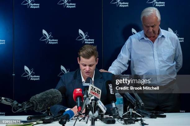 An emotional Steve Smith is comforted by his father Peter as he confronts the media at Sydney International Airport on March 29, 2018 in Sydney,...