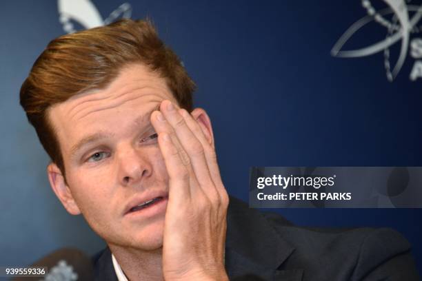 Australian cricketer Steve Smith reacts at a press conference at the airport in Sydney on March 29 after returning from South Africa. Distraught...