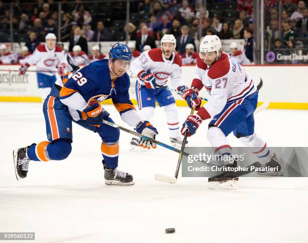 Brock Nelson of the New York Islanders Alex Galchenyuk of the Montreal Canadiens to commit a defensive zone turnover during the first period at...