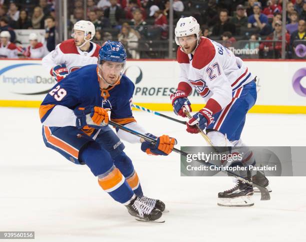 Brock Nelson of the New York Islanders Alex Galchenyuk of the Montreal Canadiens to commit a defensive zone turnover during the first period at...