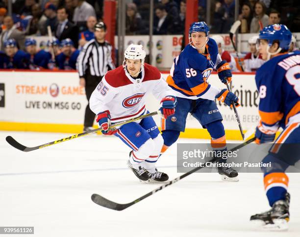 Andrew Shaw of the Montreal Canadiens and Tanner Fritz of the New York Islanders skate during the second period at Barclays Center on March 2, 2018...