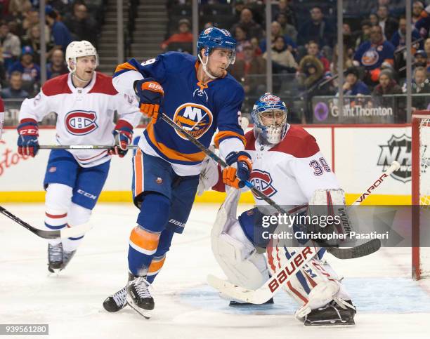 Brock Nelson of the New York Islanders skates against Charlie Lindgren of the Montreal Canadiens during the third period at Barclays Center on March...